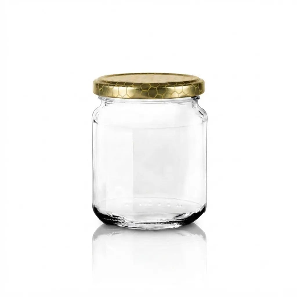 A clear glass jar with a gold metal lid, shown on a white background with a soft reflection underneath.